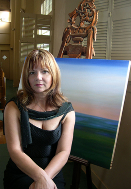 Aleta in front of a painting of Biscayne Bay